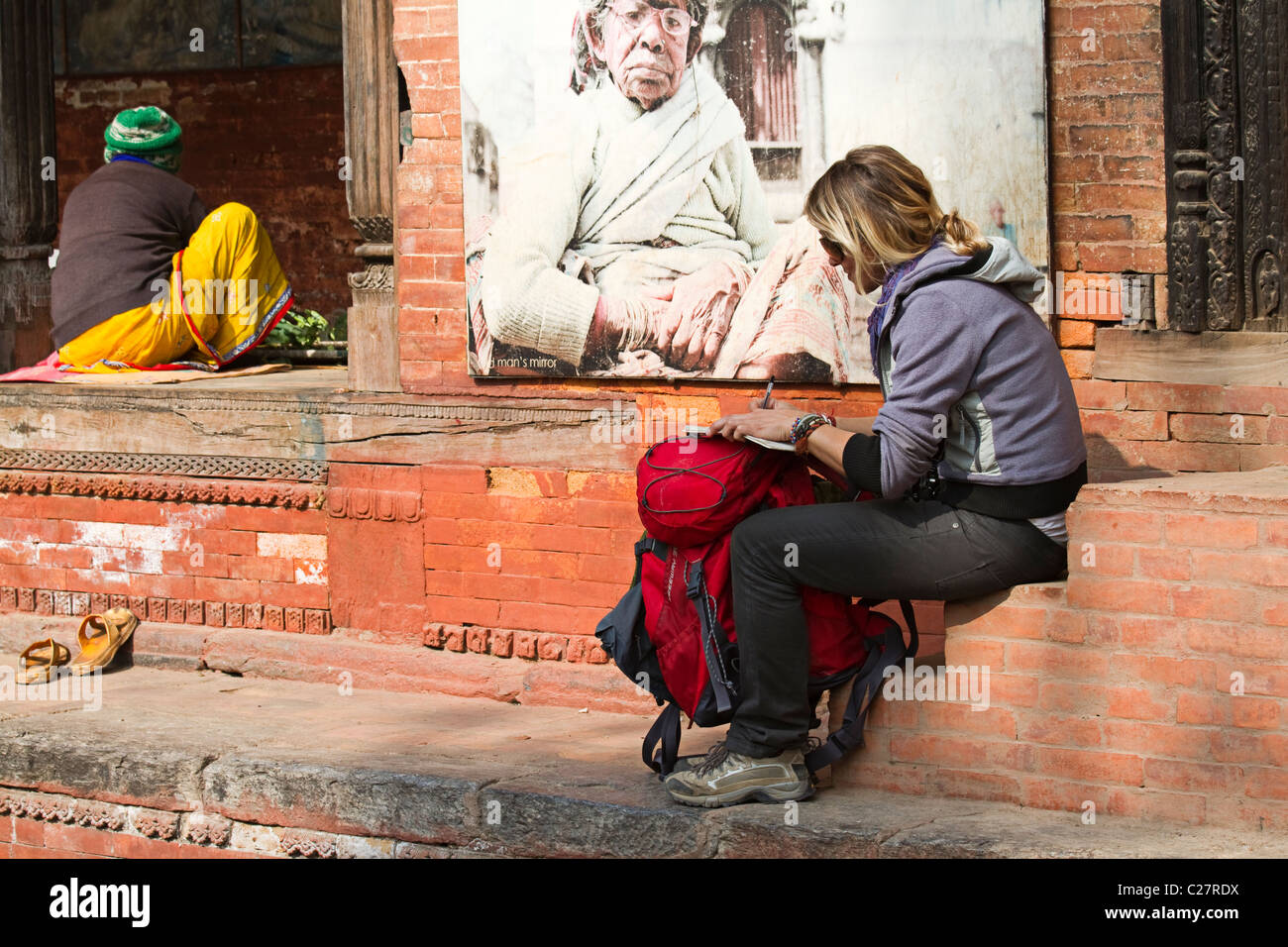 Girl writing on her backpack. Kathmandu 