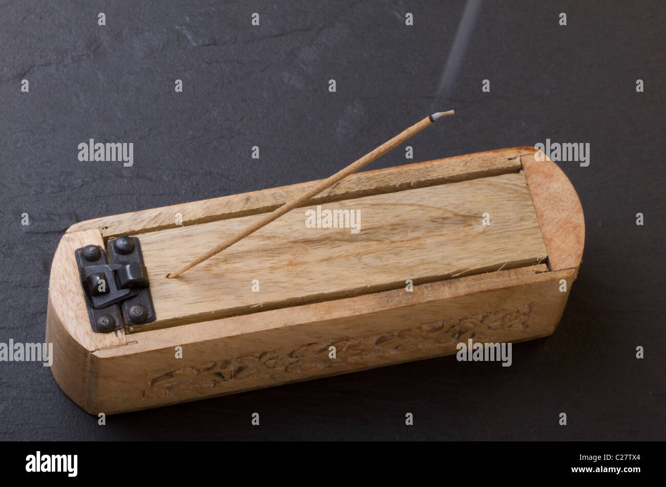 Carved wooden incense burner against dark background Stock Photo - Alamy
