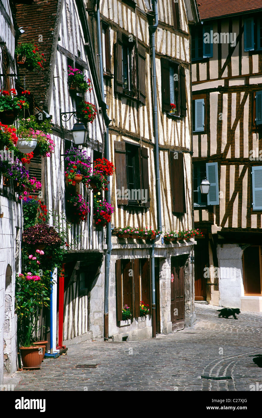 Flower boxes brighten the historic Tudor Style homes in the medieval town of Auxerre, France Stock Photo