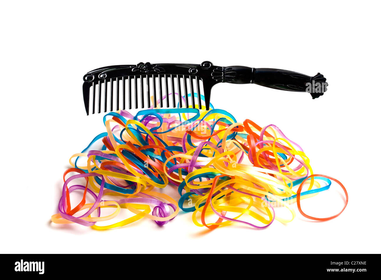 colorful rubber bands and comb closeup on white background Stock Photo