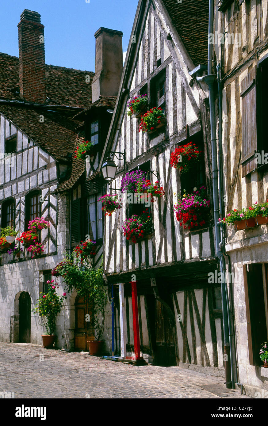 Flower boxes brighten the historic Tudor Style homes in the medieval town of Auxerre, France Stock Photo