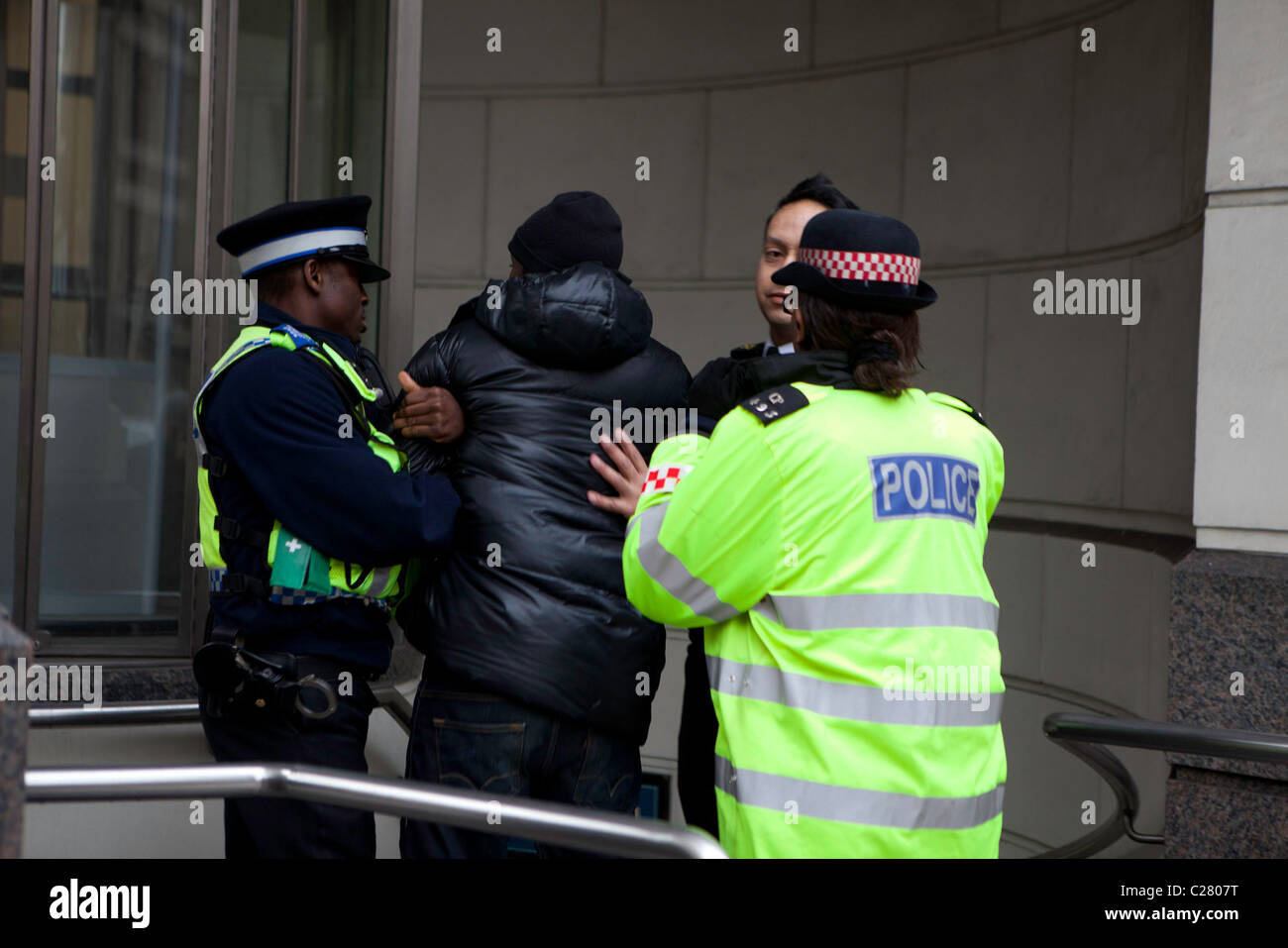 A young black male is arrested on Ludgate Hill. It took 10 police officers from various forces to overcome and arrest him. Stock Photo