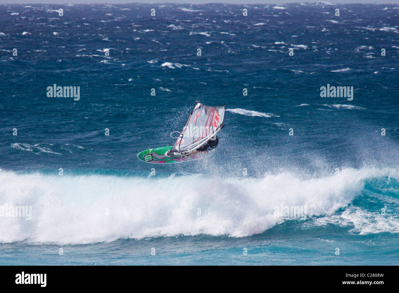 Tacking Horizontal. Extreme Windsurfing on Mauis famous Hookipa Beach
