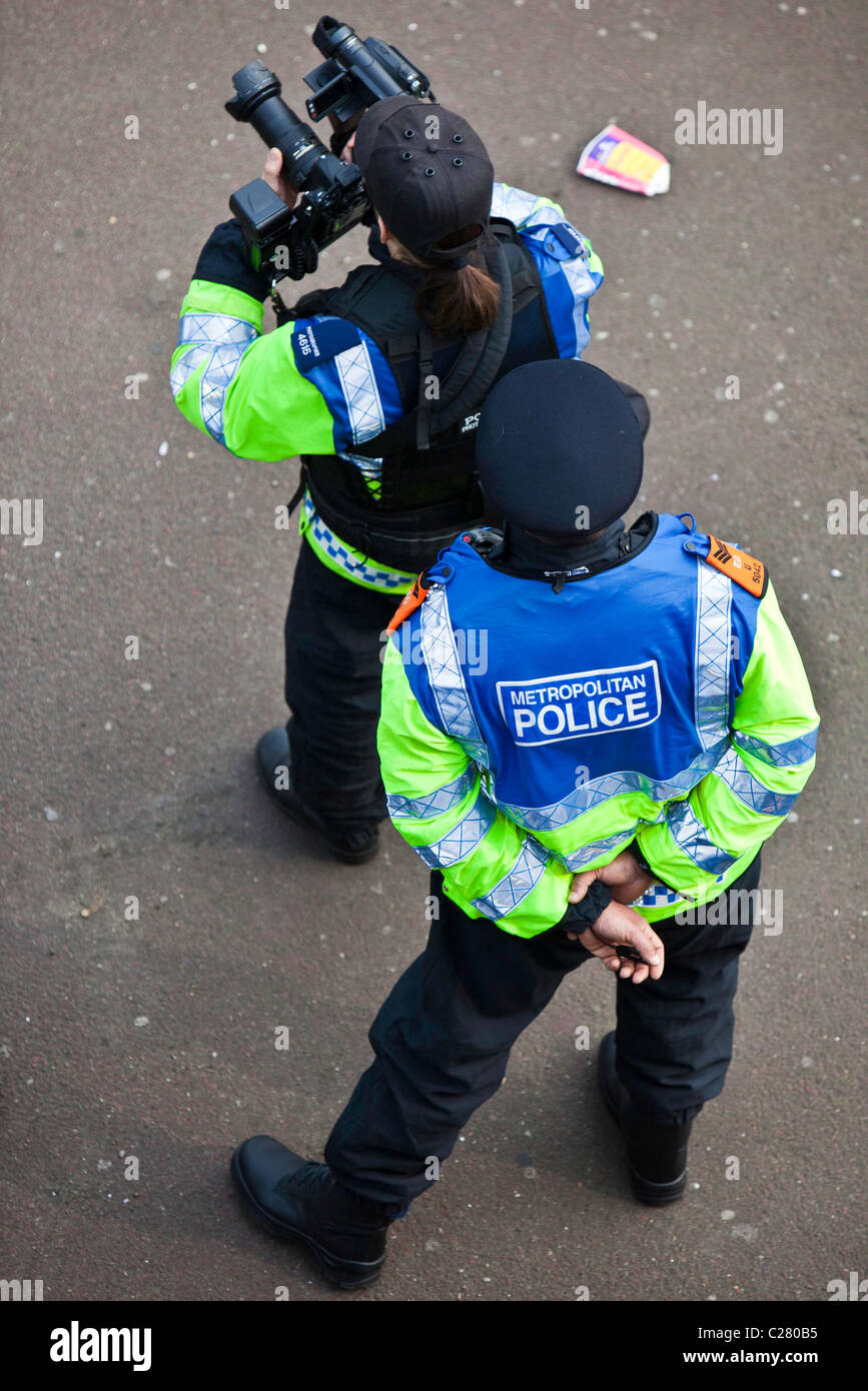 Police document protest using still and video cameras. Stock Photo