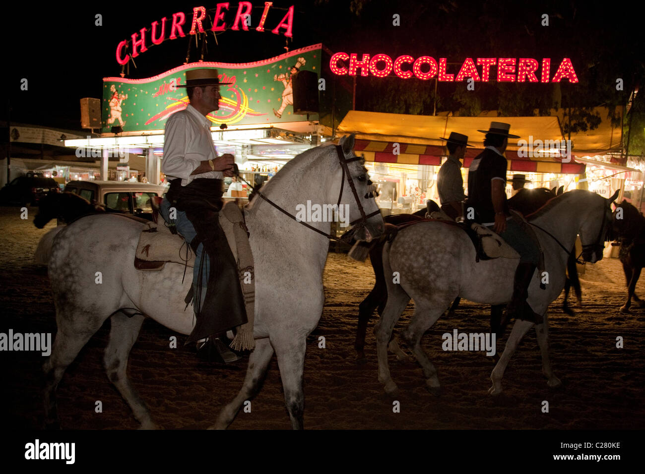 Riders passing fast food stalls at El Rocio during the annual religious pilgrimage (romeria) Stock Photo