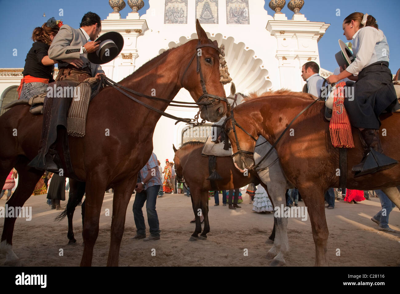 Horse riders paying respect in front of the Church of Our Lady at El Rocio at the end of their Catholic pilgrimage. Stock Photo