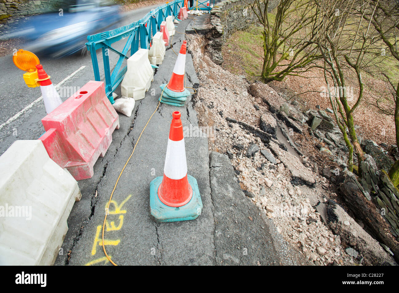 A road in the Langdale Valley collapsed due to extreme weather. Infrastructure damage is becoming more common due to extreme wea Stock Photo