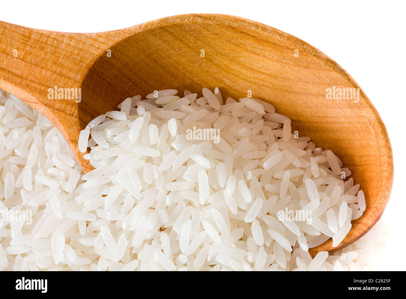 White long uncooked rice on wooden spoon Stock Photo