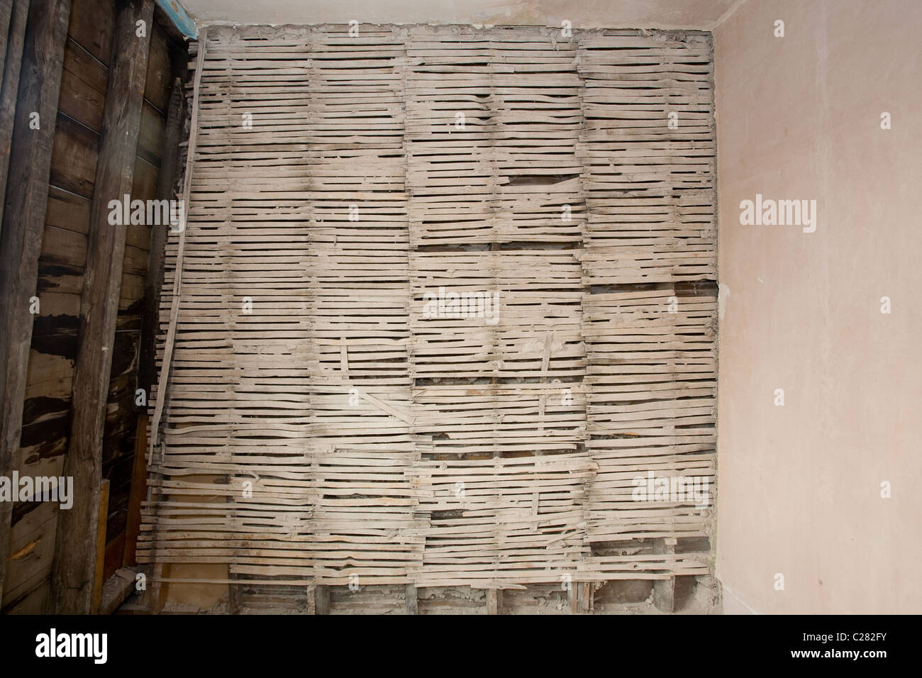 Lath wall with plaster removed Stock Photo