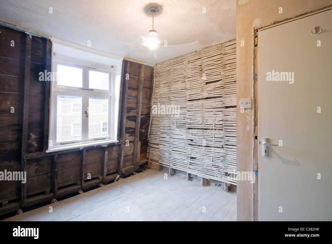Lath Wall With Plaster Removed And Stud Wall In Room Undergoing