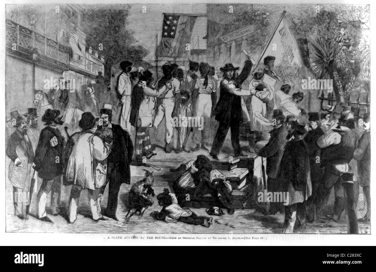 A slave auction at the south.  African American men, women, and children being auctioned off in front of crowd of men. Stock Photo