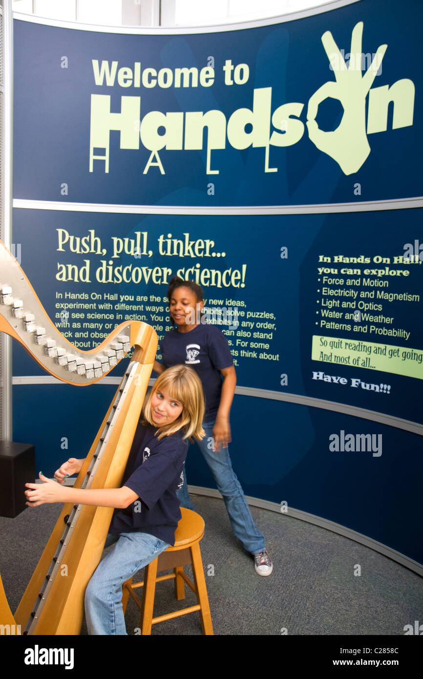 Child playing an electronic stringless harp at the Gulf Coast Exploreum Science Center in Mobile, Alabama, USA. Stock Photo
