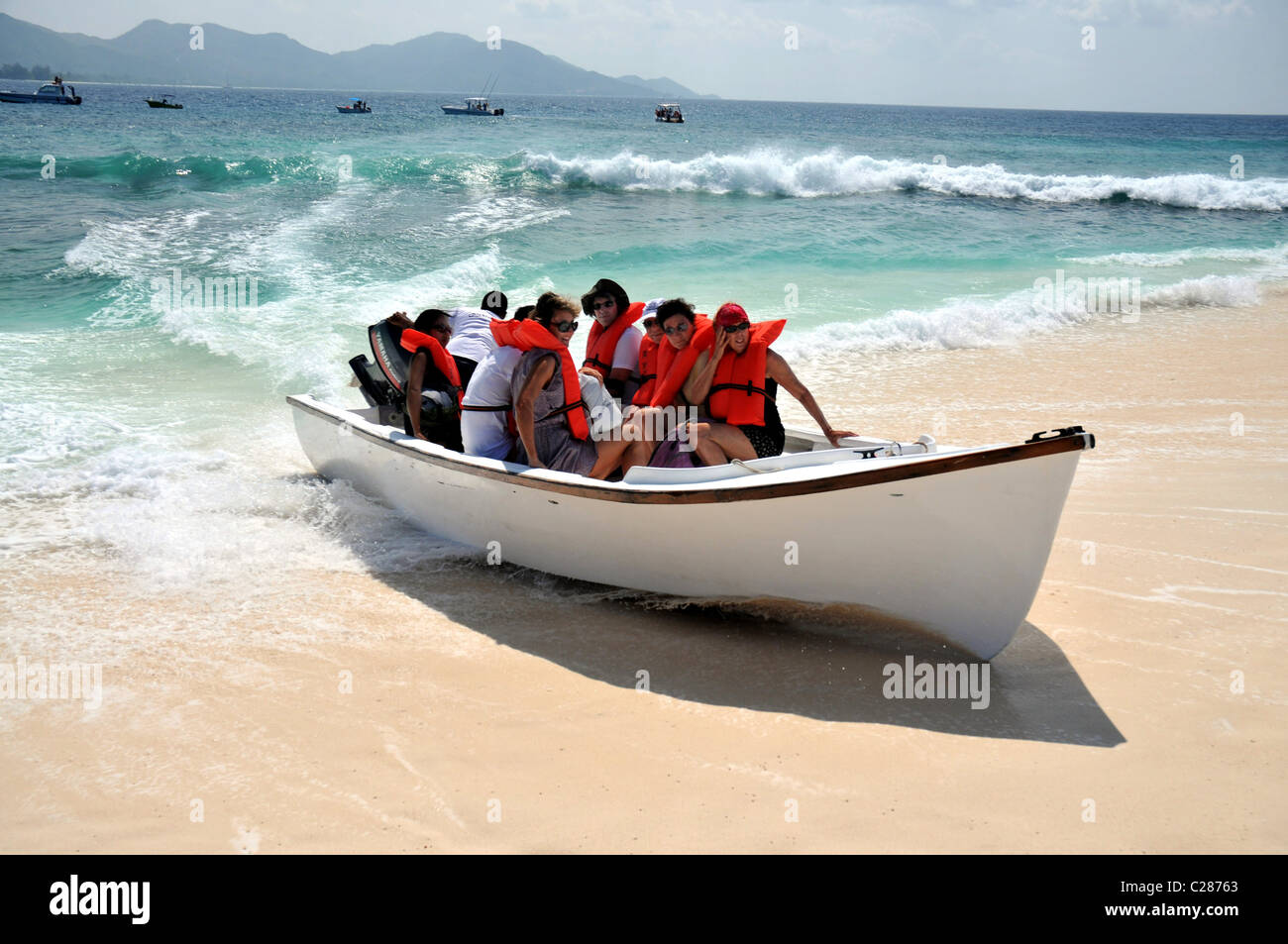 Fast arrival of tourist boat direct onto the beach at Cousin Island Seychelles. Stock Photo