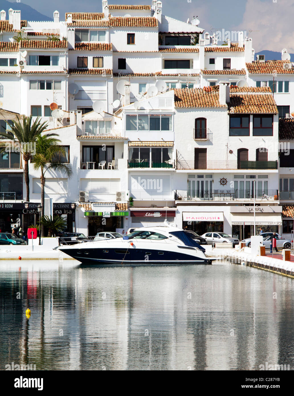 Motor launch/boat moored in Puerto Banus marina near Marbella Costa del Sol  Spain with white apartments in background Stock Photo - Alamy