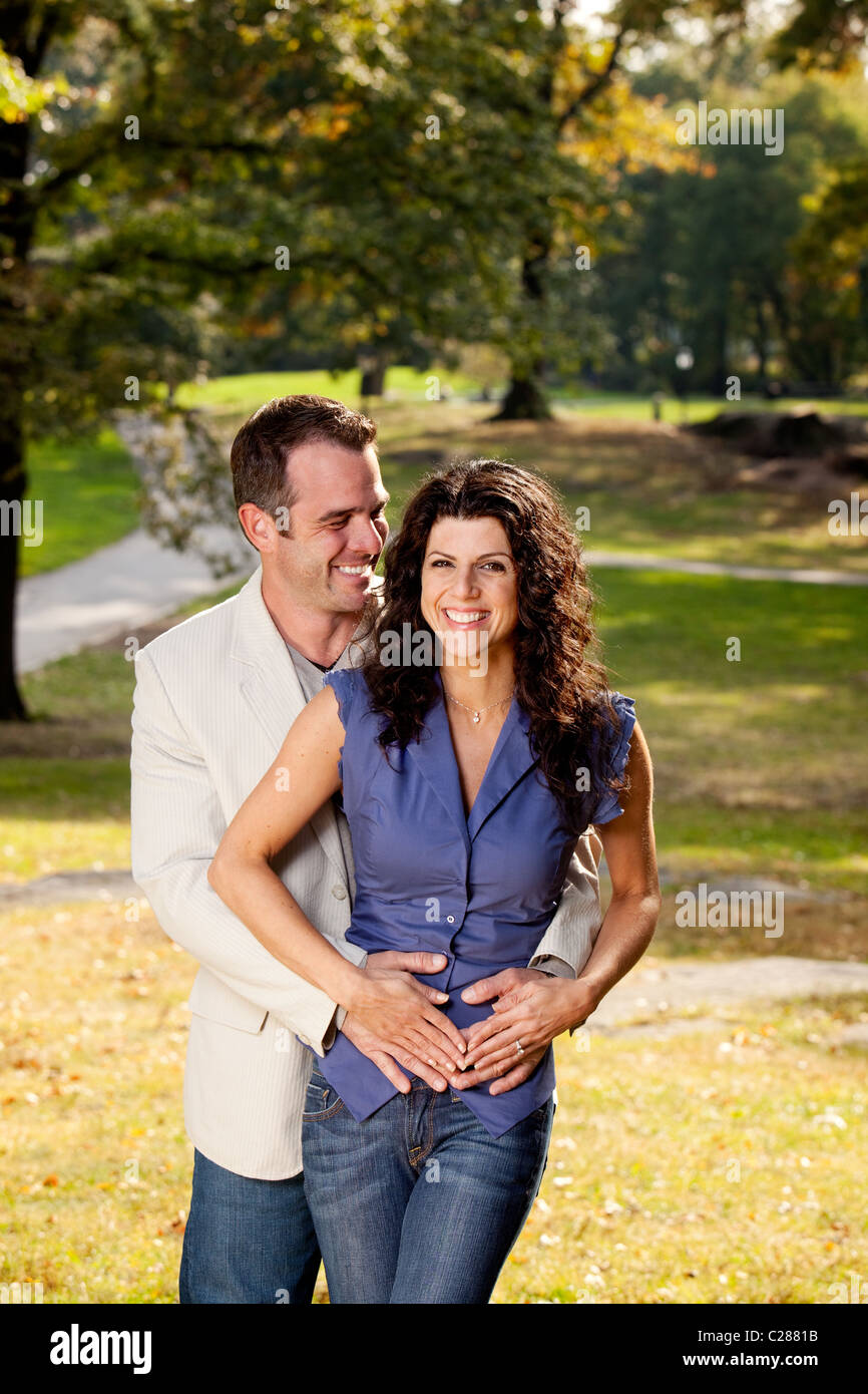 A happy couple in the park hugging Stock Photo - Alamy