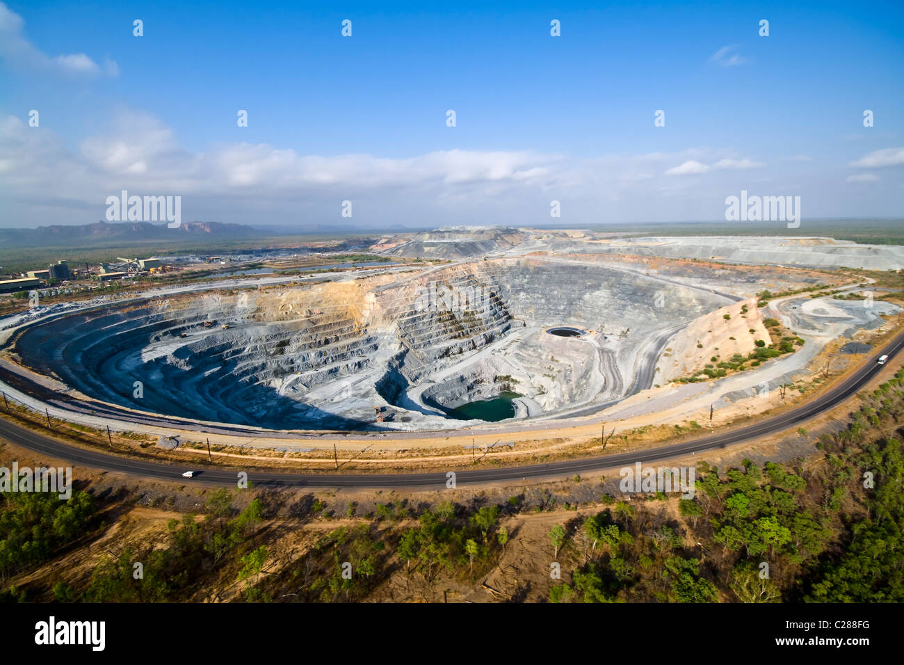 A massive tiered open cut uranium mine within Kakadu National Park. Stock Photo