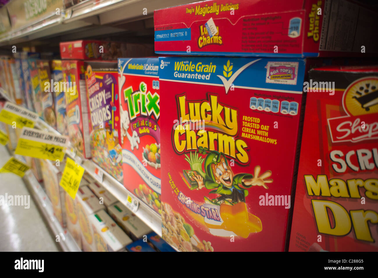 Boxes of General Mills' Lucky Charms, Trix and other breakfast cereals on supermarket shelves in New York Stock Photo
