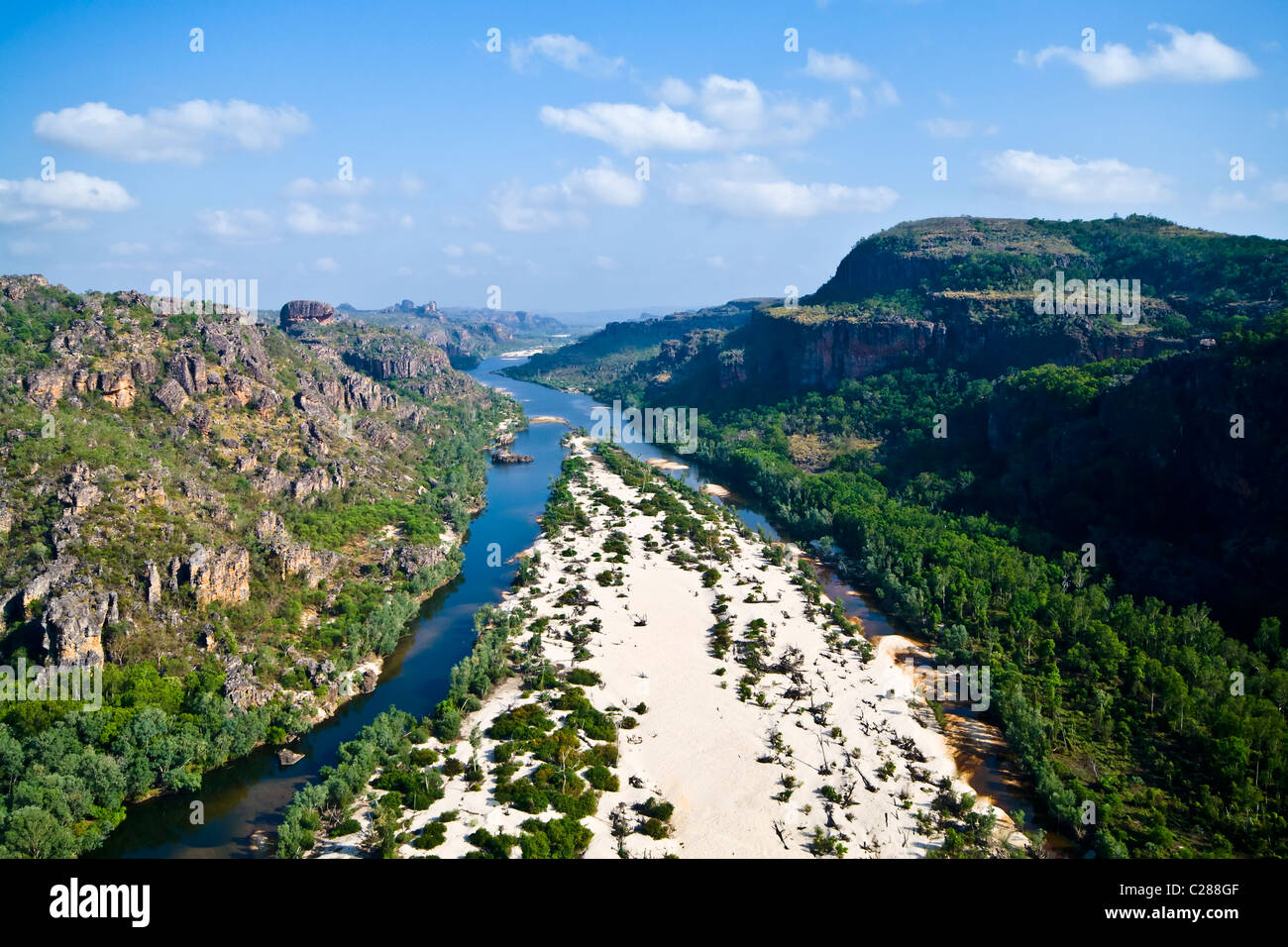 A river forks around a sand island in a rugged escarpment gorge. Stock Photo
