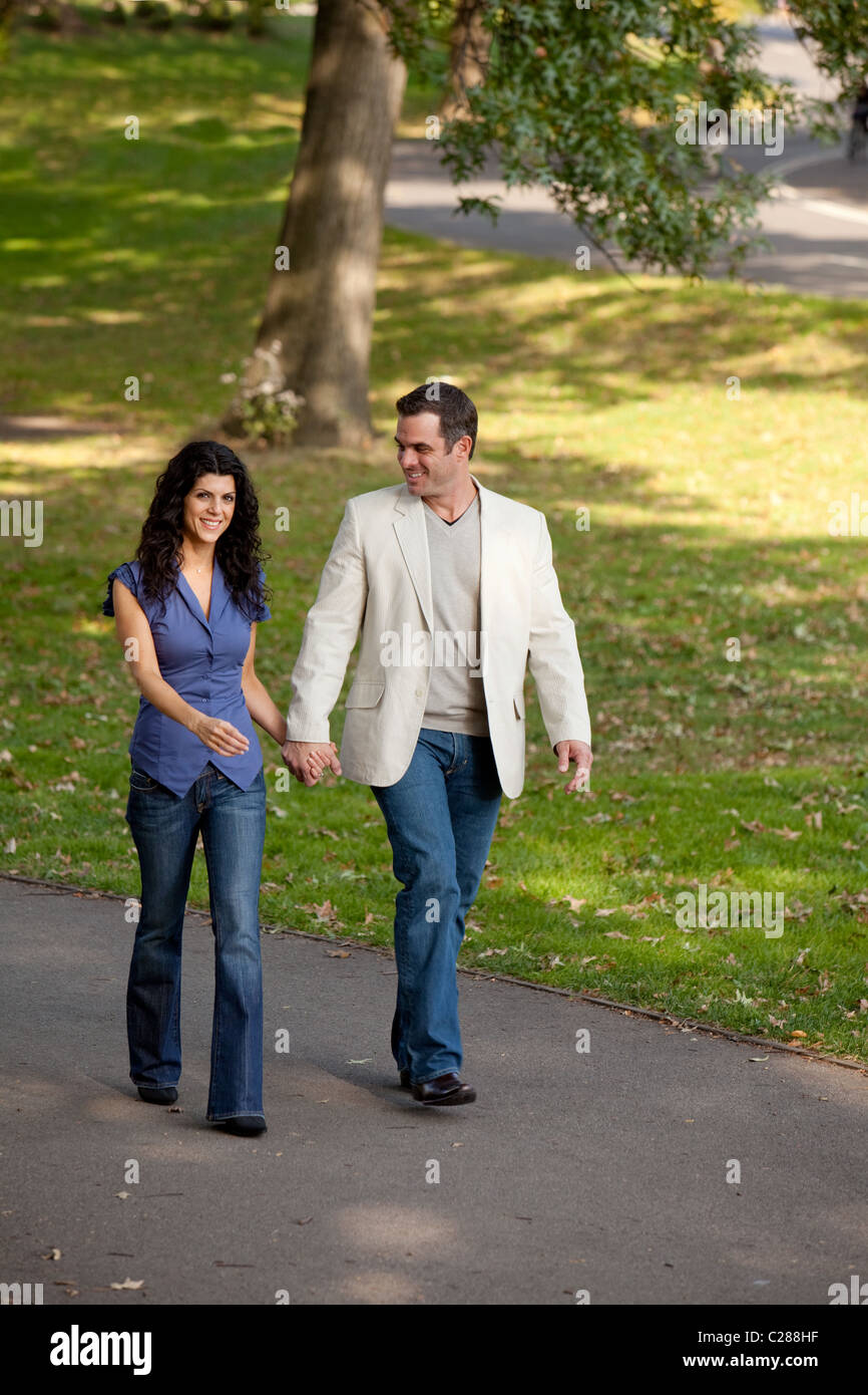 A happy couple walking in the park Stock Photo - Alamy