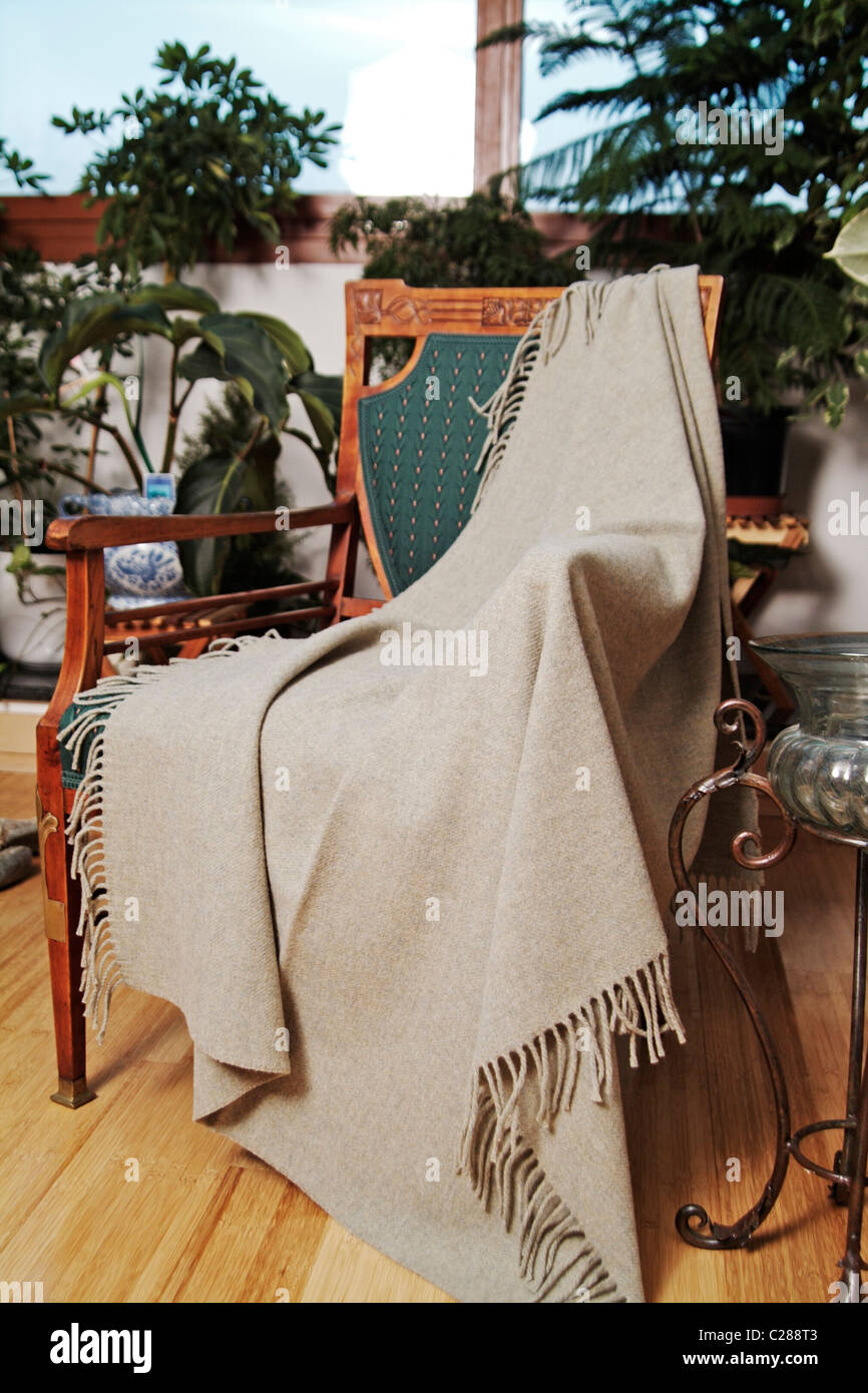 Throw draped over an antique chair Stock Photo Alamy