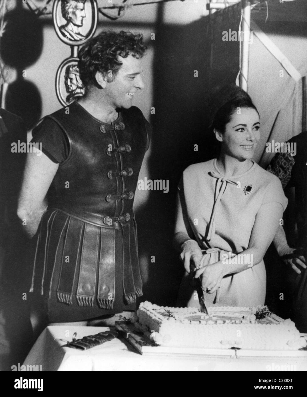 Actress Liz Taylor cuts cake with sword Stock Photo