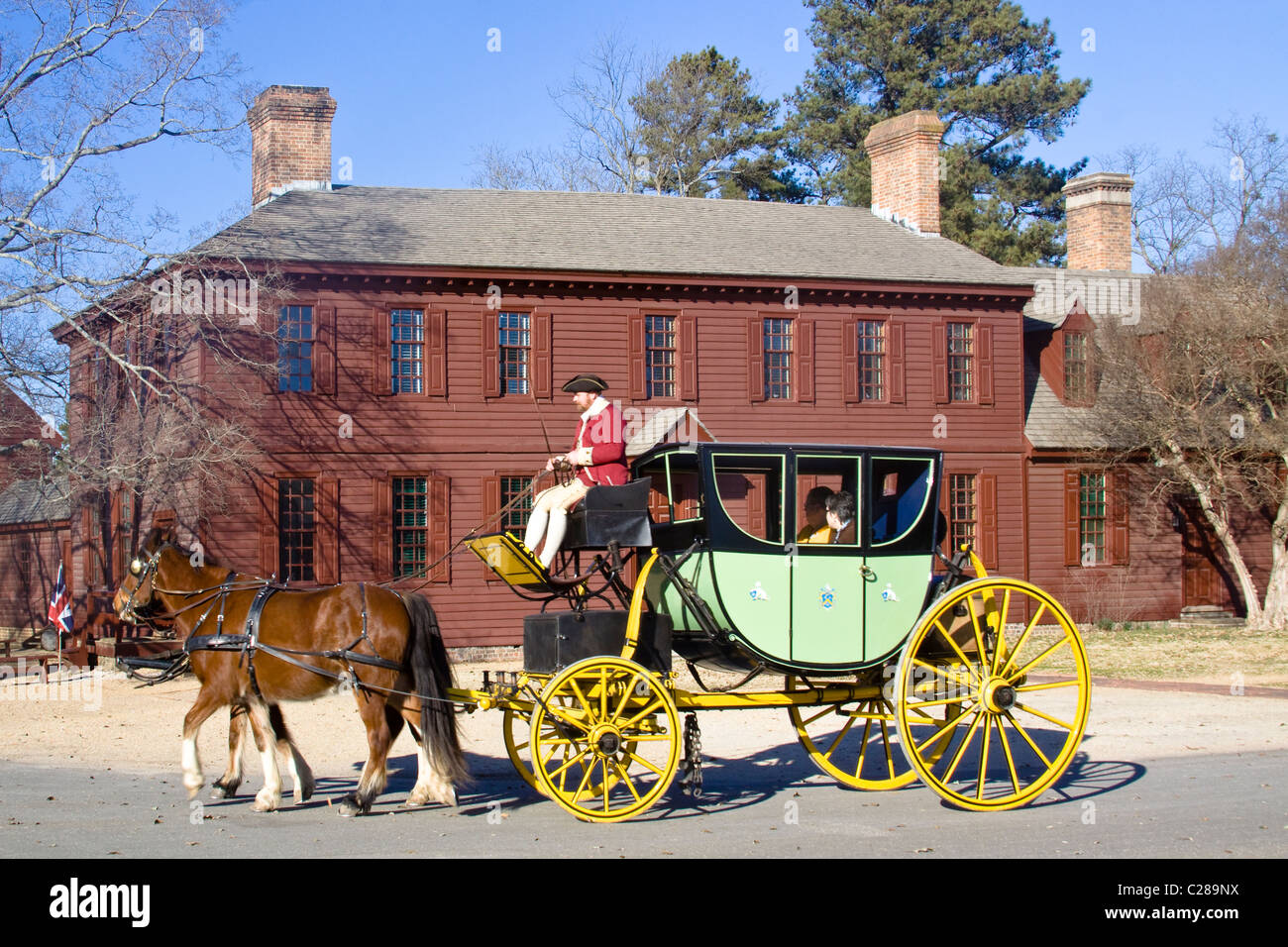 Colonial coachman with driving whip on a horse and carriage historic