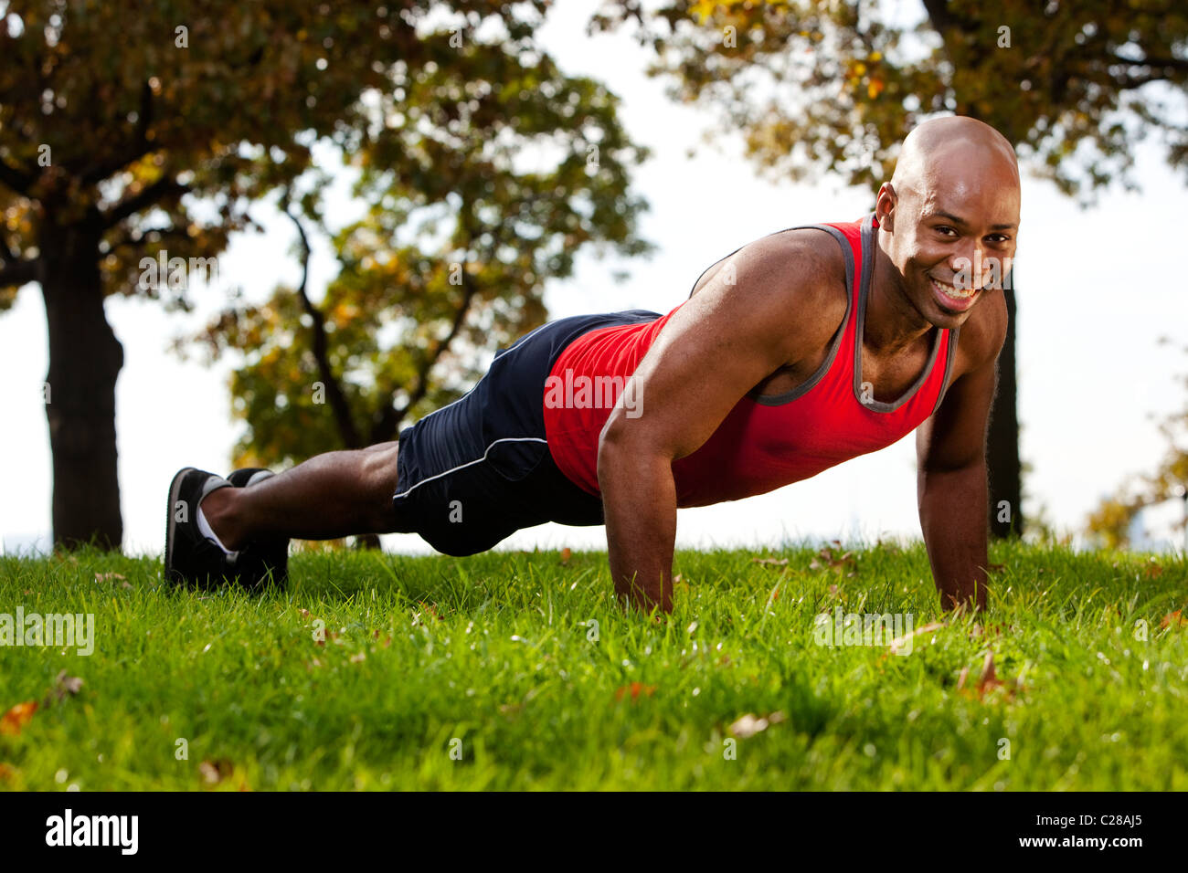 A man doing a push up in a park Stock Photo - Alamy
