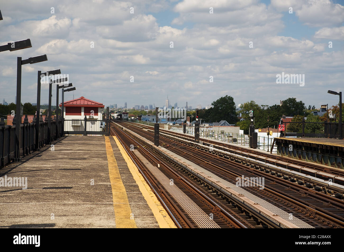 Tracks at a train stop in Brooklyn, New York, city buildings in the