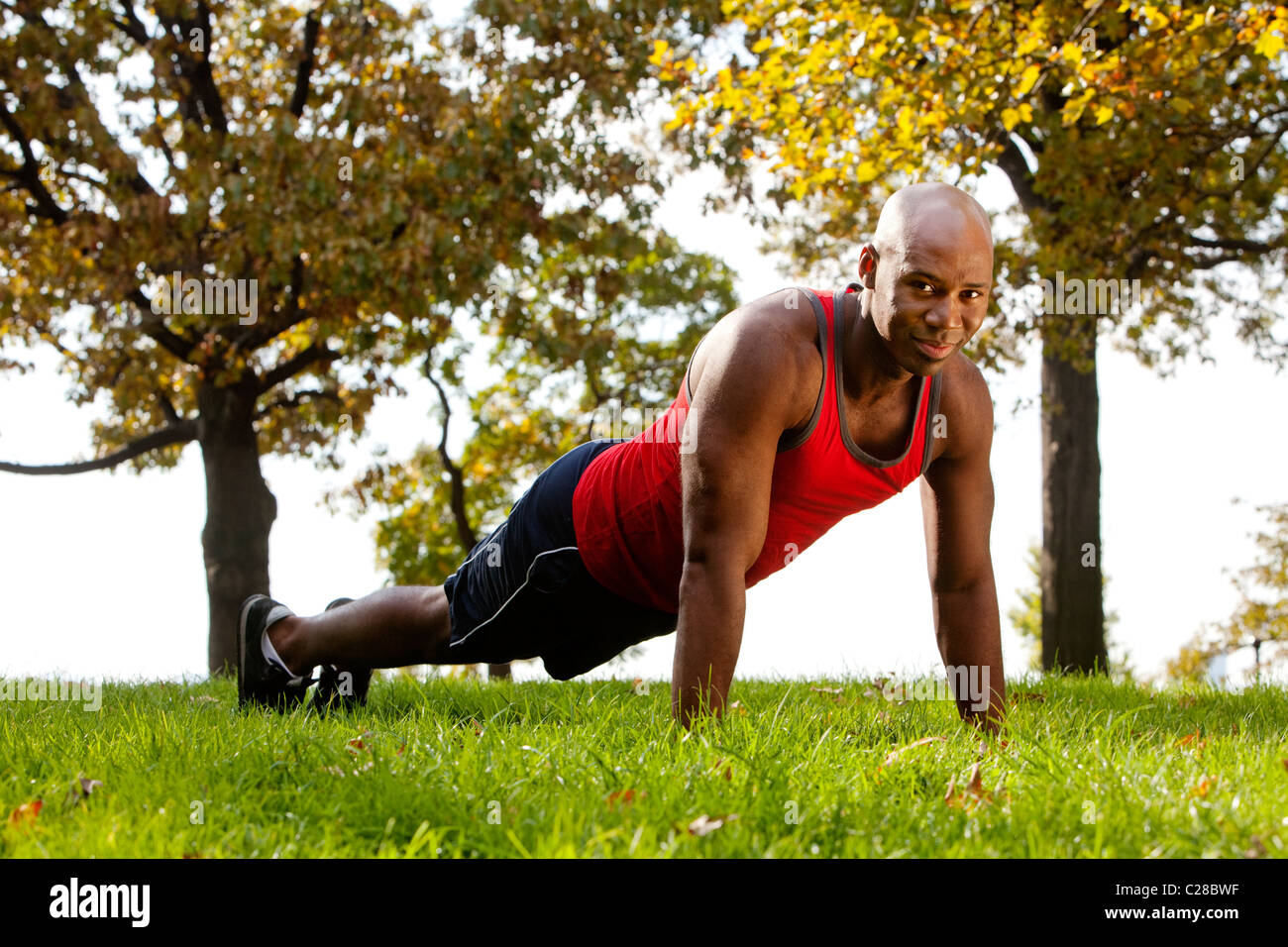 An african american doing exercises in the park Stock Photo - Alamy