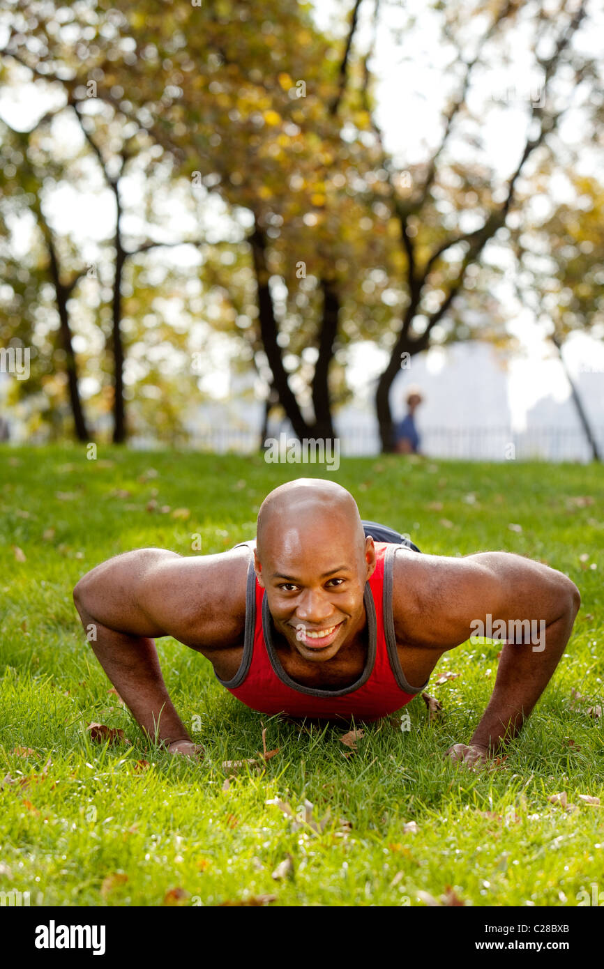 An african american doing push ups in the park Stock Photo - Alamy