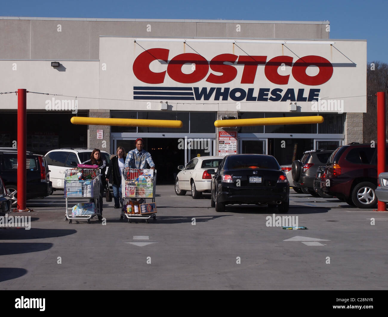 People with shopping carts outside of Costco Wholesale, a USA big box chain store, March 24, 2011, Katharine Andriotis Stock Photo
