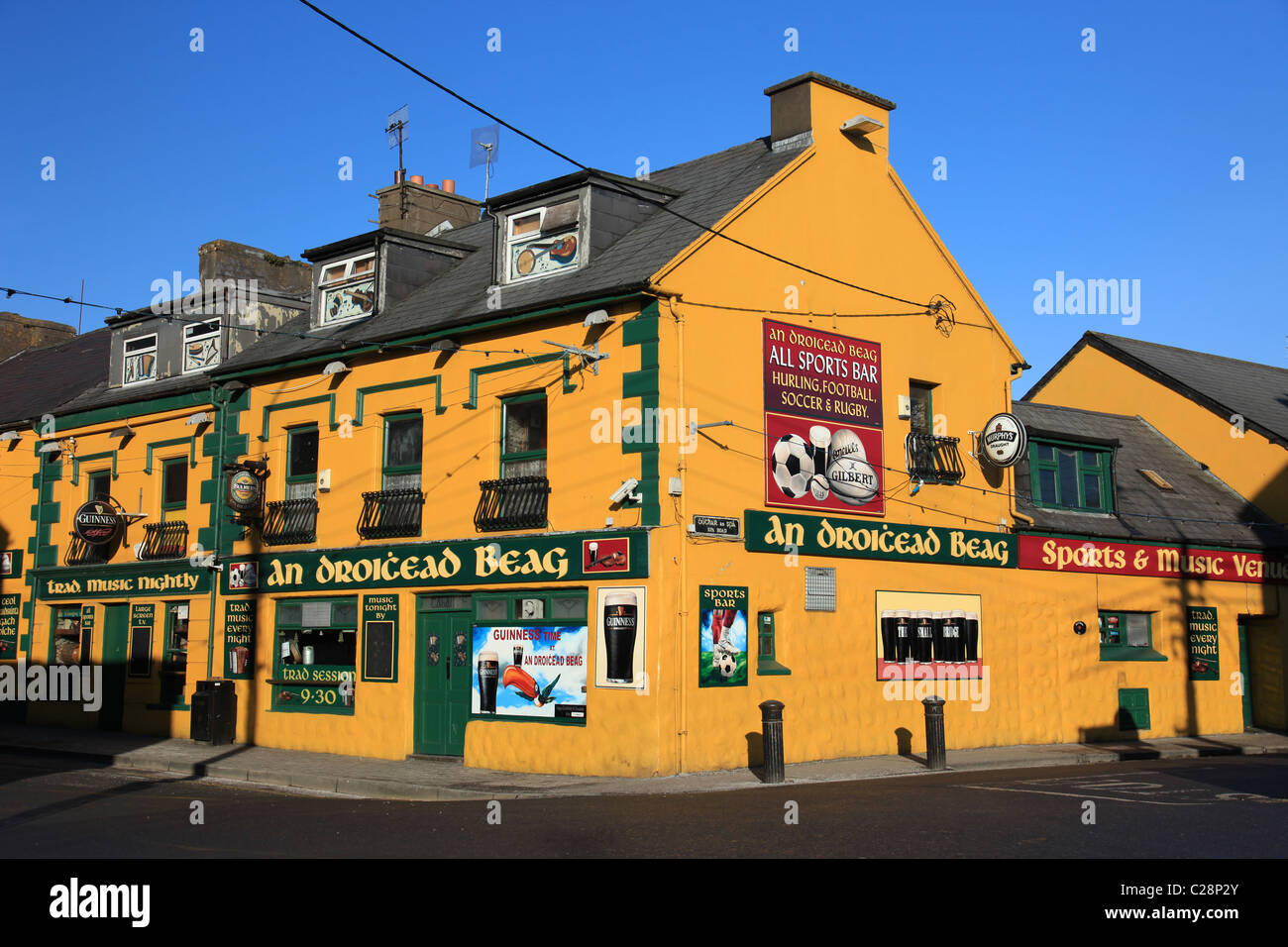 Ireland, co kerry, dingle, bright colored painted bar in an irish town