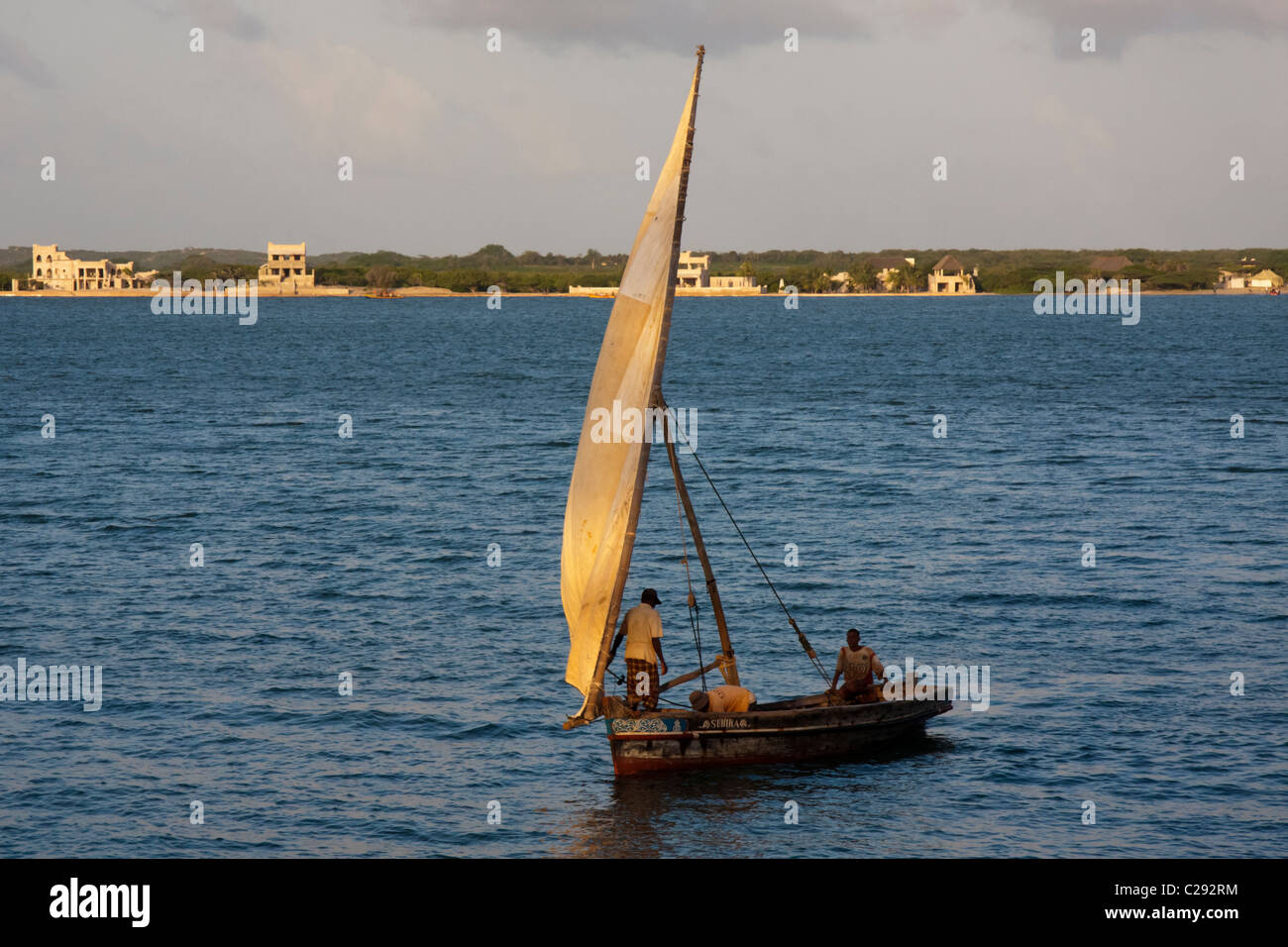 A Swahili boat sailing off the coast of Lamu Island, Kenya Stock Photo