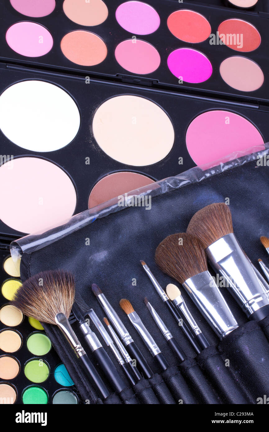 Professional make-up brushes on eyeshadows palettes, closeup Stock Photo