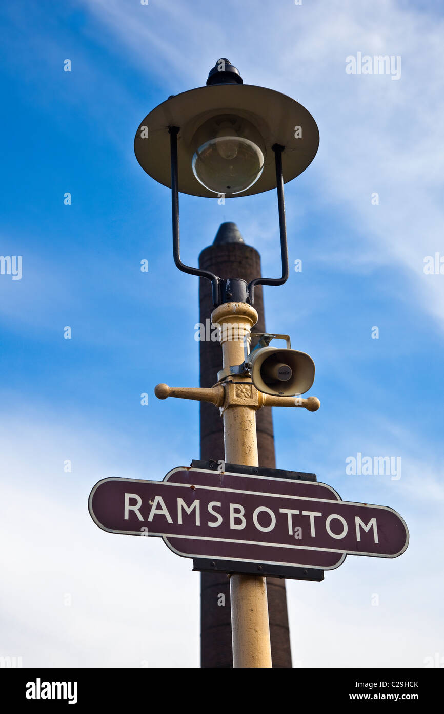 Railway Station sign in front of coton mill chimney  Ramsbottom on the East Lancs Railway, Lancashire, UK Stock Photo