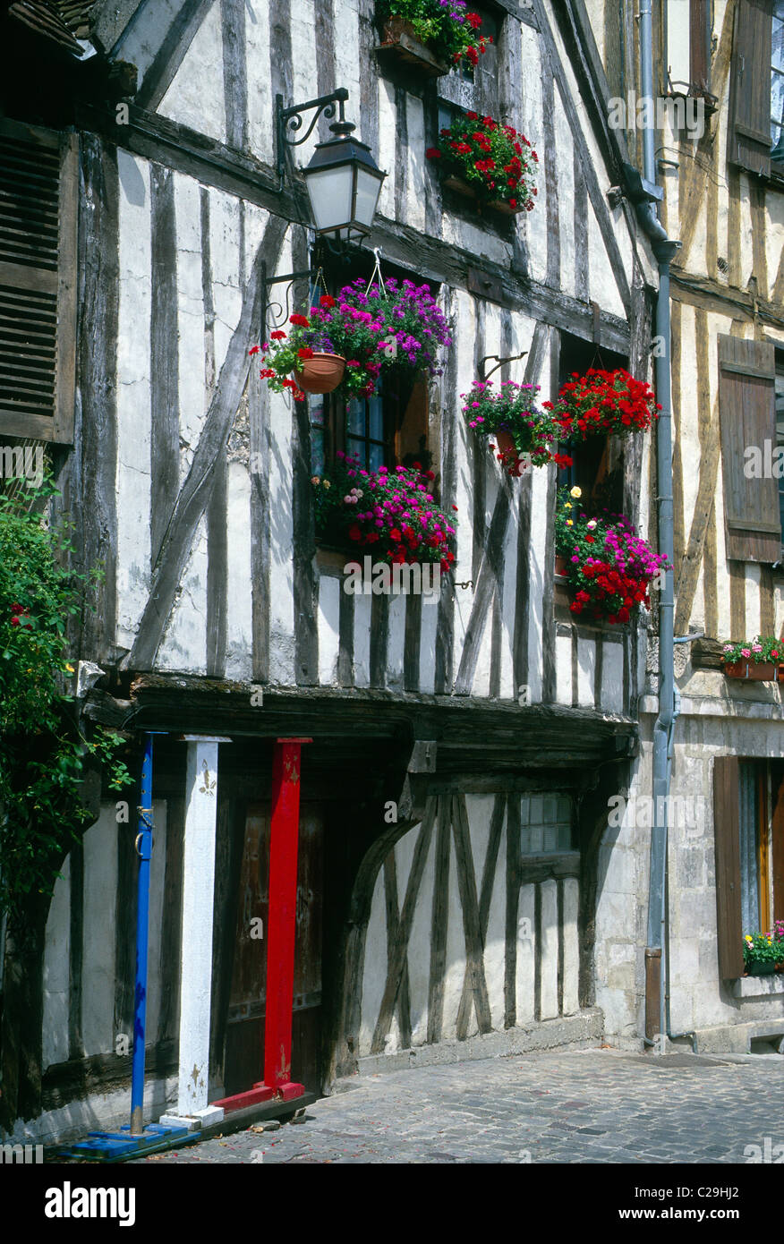 Flower boxes brighten the historic Tudor Style homes in the medieval town of Auxerre, France Stock Photo