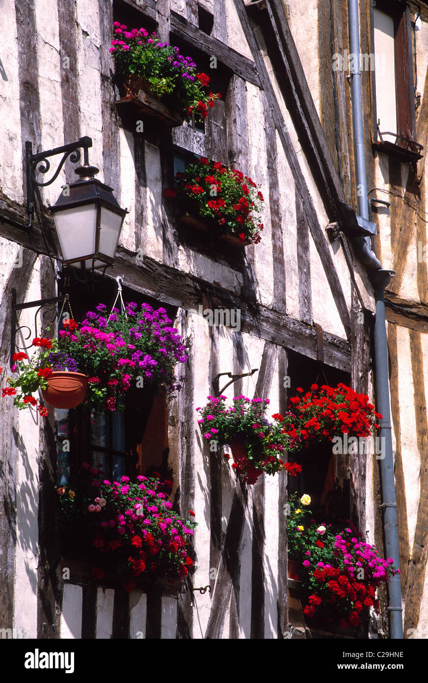 Flower boxes brighten the historic Tudor Style homes in the medieval town of Auxerre, France Stock Photo