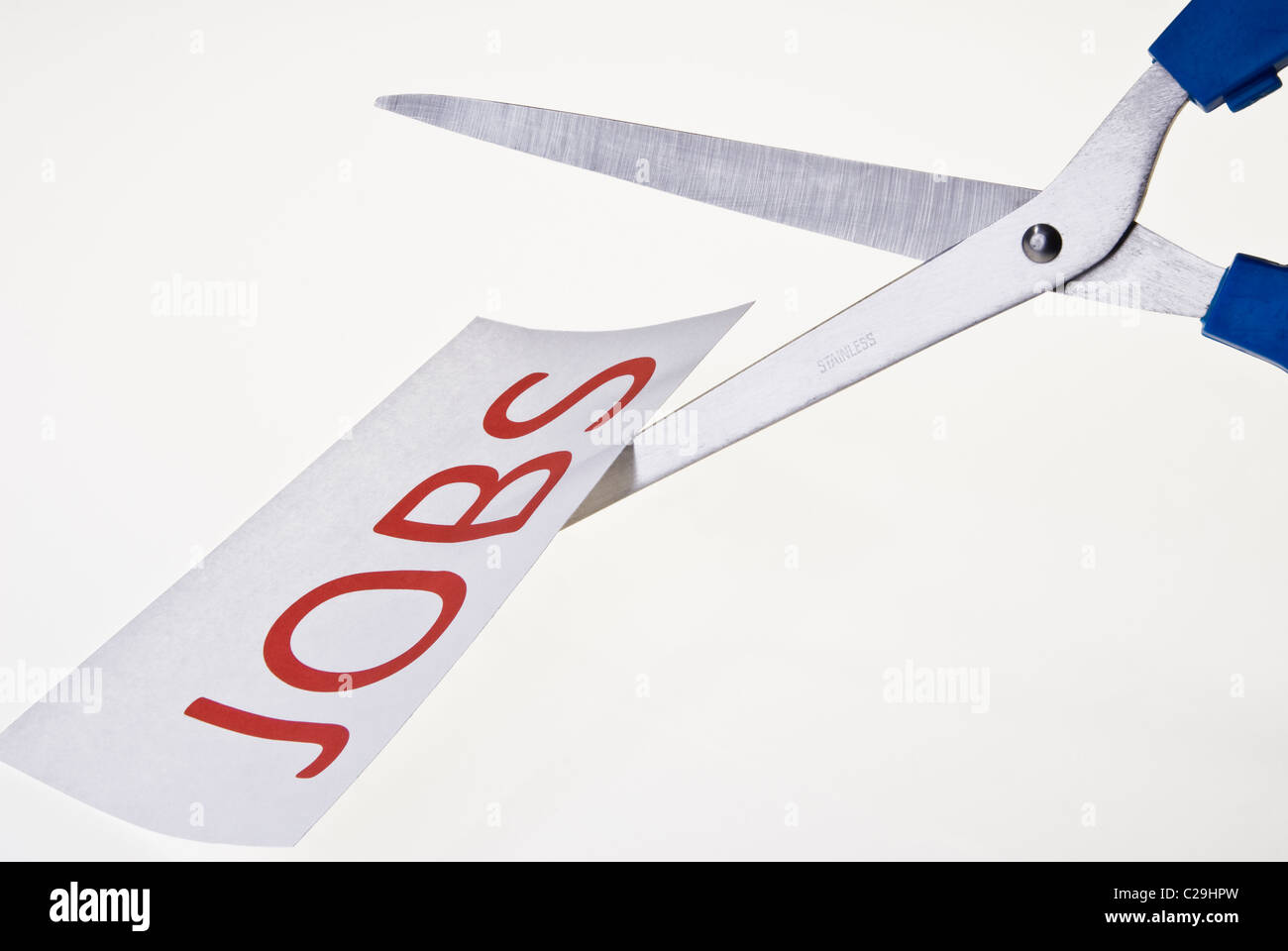 Job Cuts. Scissors cutting paper Stock Photo Alamy