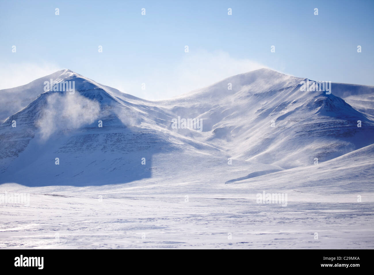 A mountain with blowing snow in a winter landscape Stock Photo - Alamy