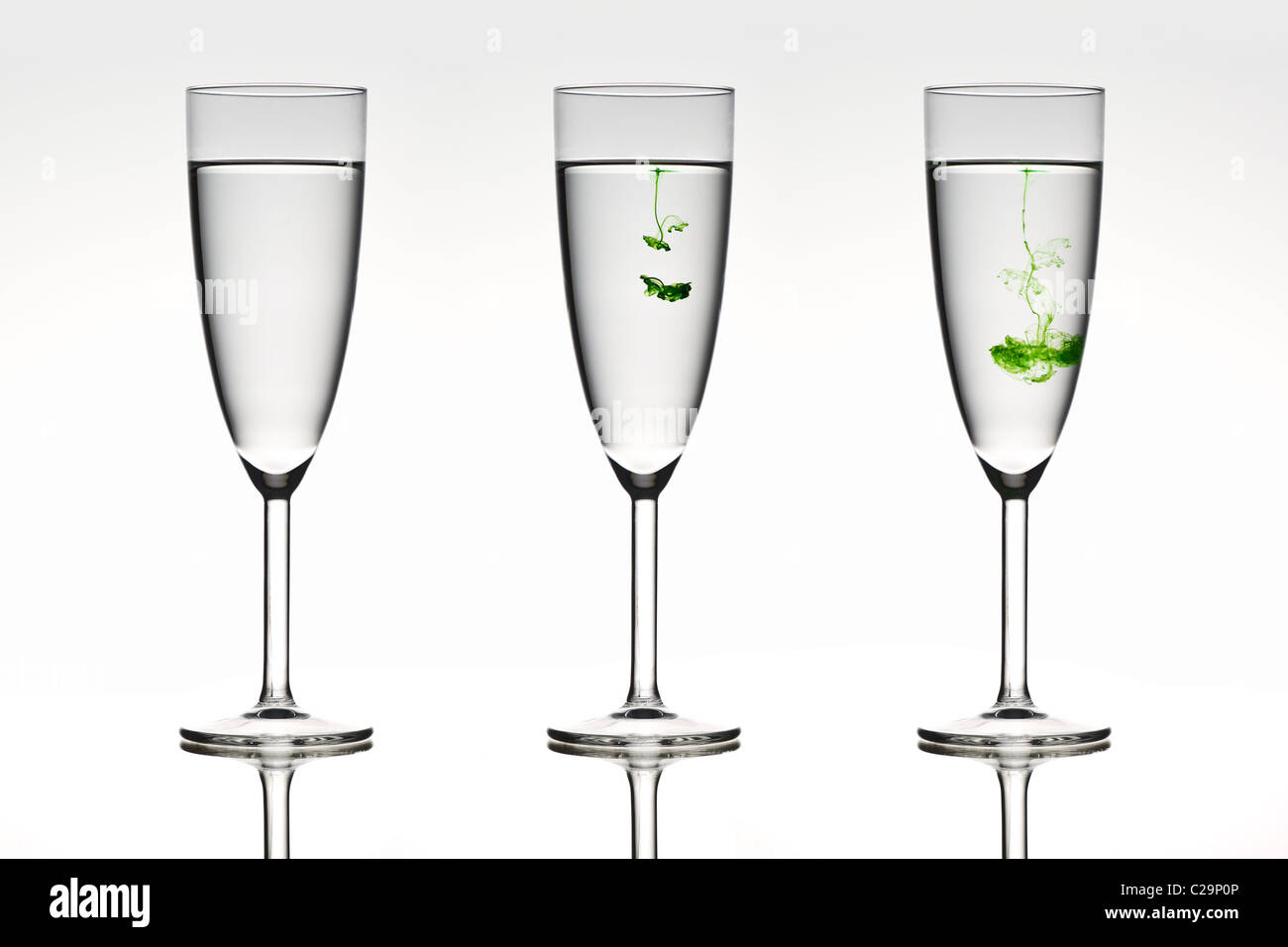 Three beautiful glasses depicting diffusion in action. Stock Photo
