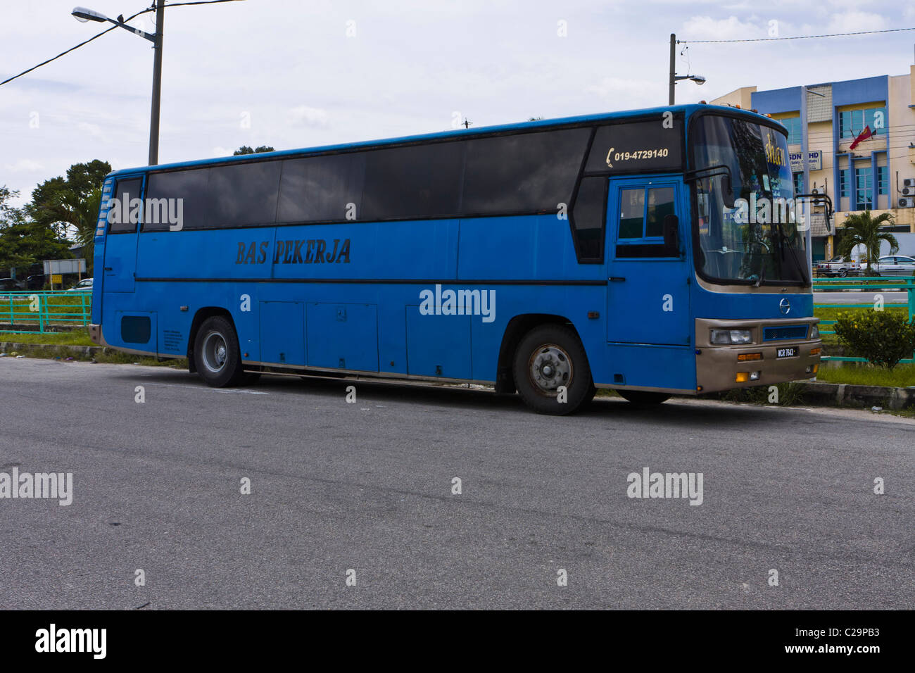A workers bus in Malaysia. These distinctive blue buses are used to  transport factory workers to the factory complexes Stock Photo - Alamy