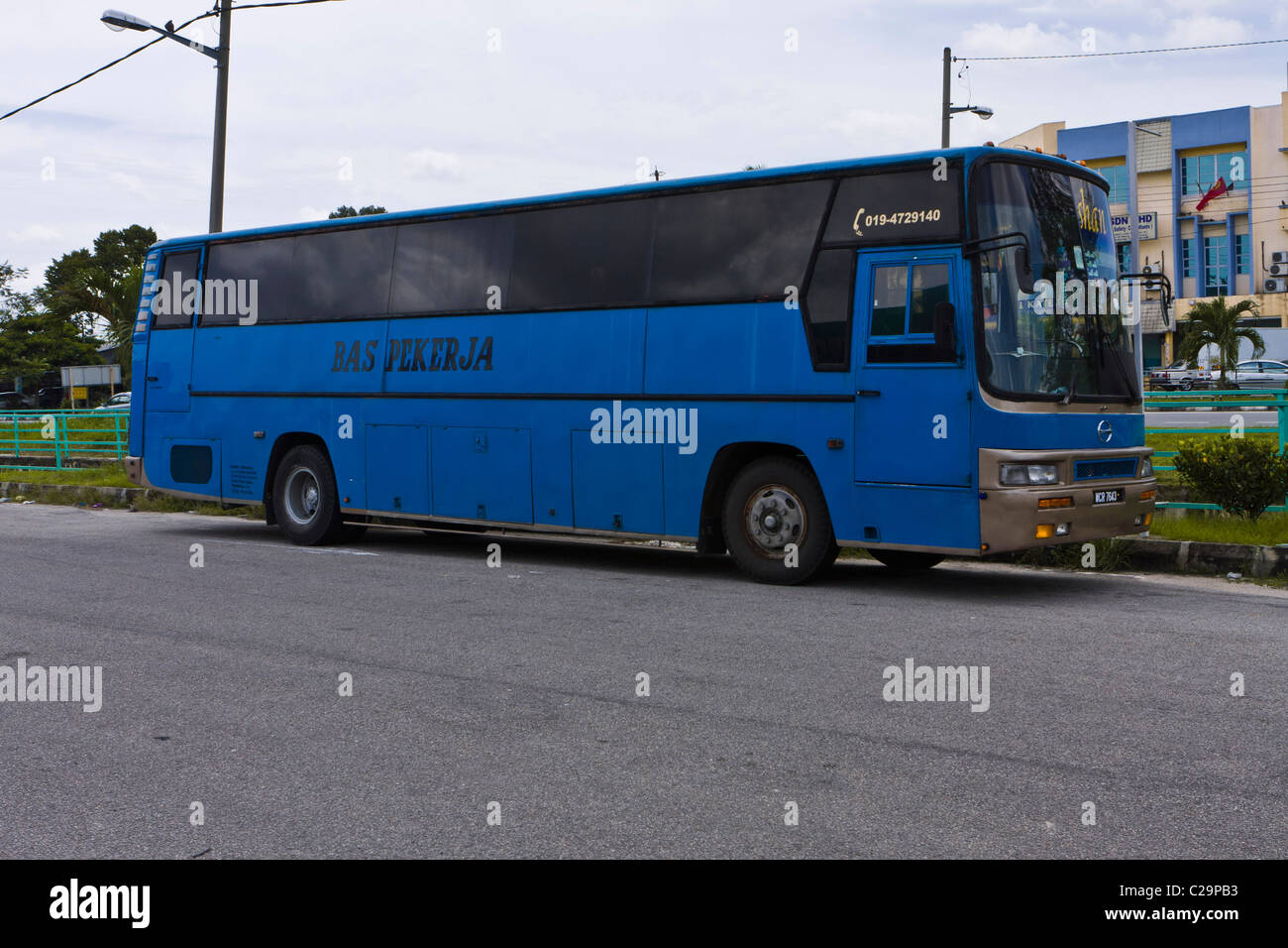 A workers bus in Malaysia. These distinctive blue buses are used to