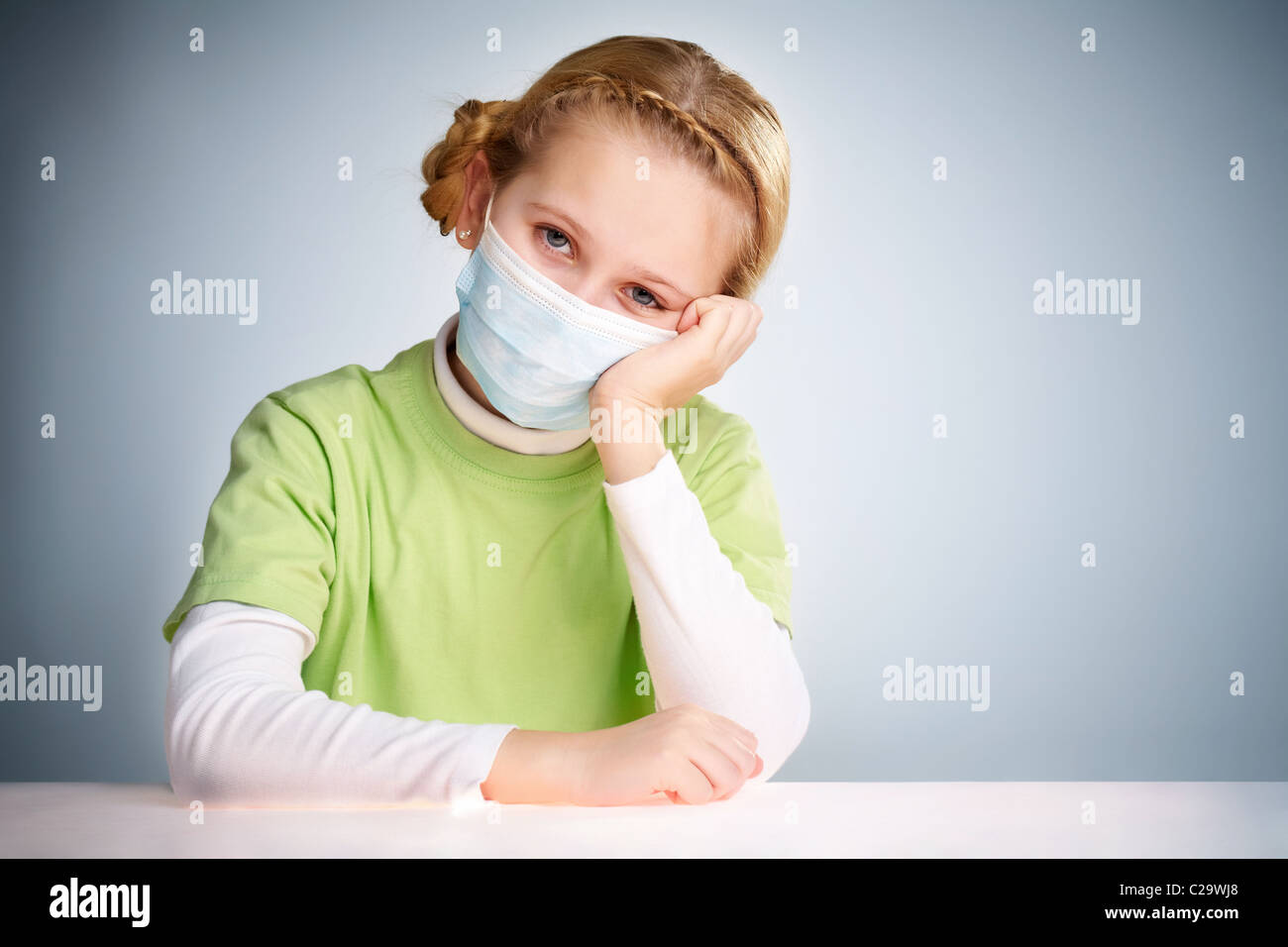 A little girl sitting in protective mask Stock Photo - Alamy