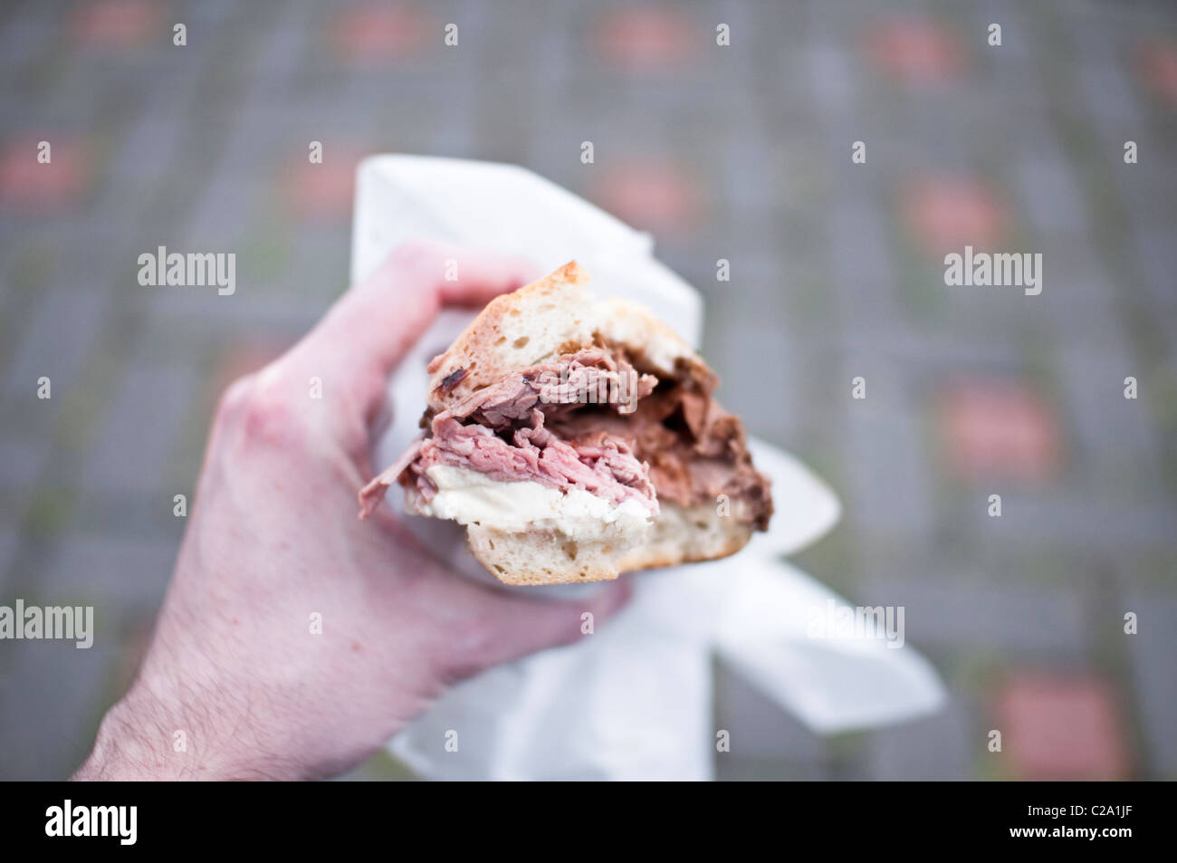 Holding a roast beef and mozzarella sandwich from the famous Fiore's Deli, Hoboken, New Jersey. A big sandwich. Stock Photo