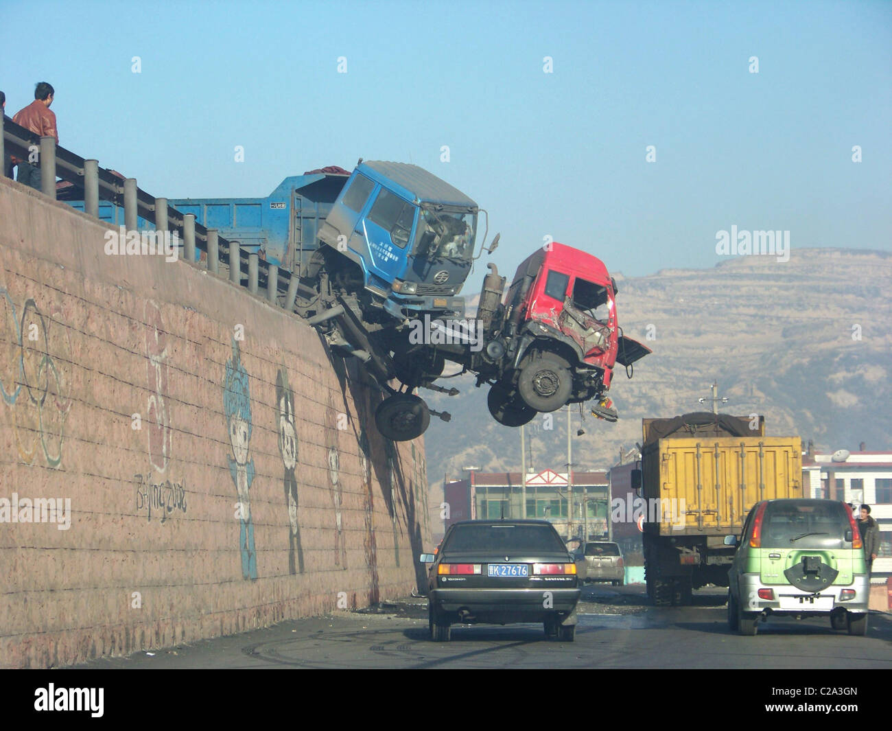A truck hangs perilously over an overpass after colliding with another vehicle on the Duanchun Bridge in Jinzhong Shanxi. The Stock Photo