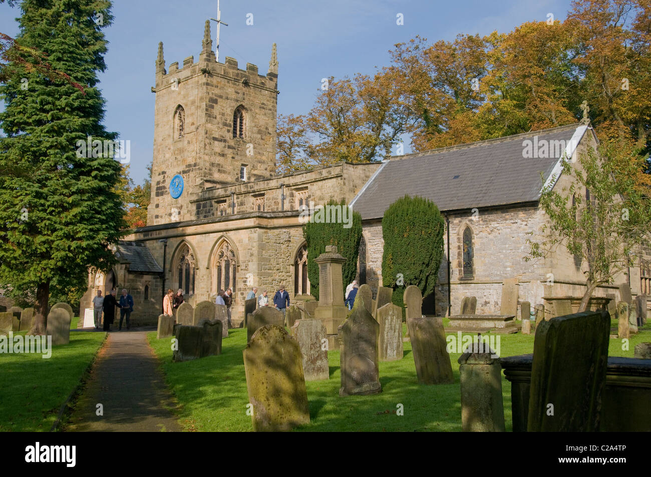 Worshipers leaving Eyam Church in Derbyshire UK Stock Photo