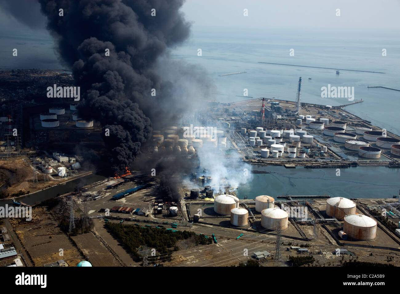 Aerial view of fire at chemical industrial complex near Sendai Shiogama Port in Sendai, Miyagi Prefecture after a 9. 0 Stock Photo