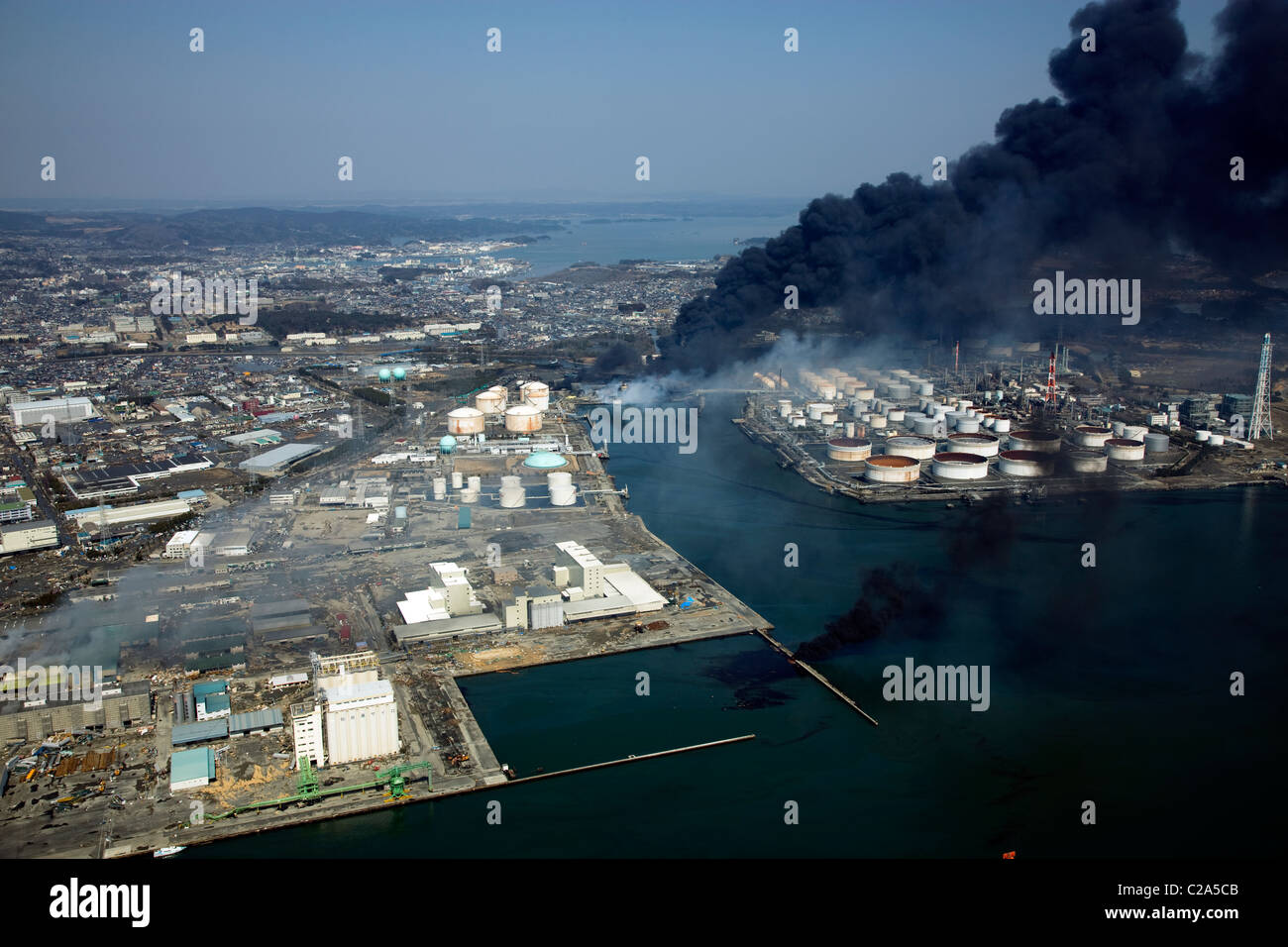 Aerial view of of damage and fire at industrial complex near Sendai Shiogama Port, Miyagi Prefecture after a 9. 0 magnitude Stock Photo