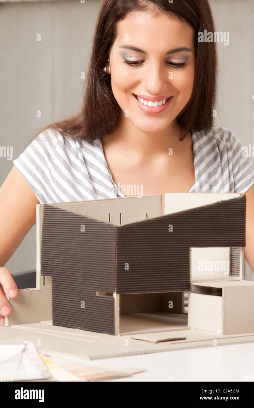 A young design student or architect building a house model Stock Photo