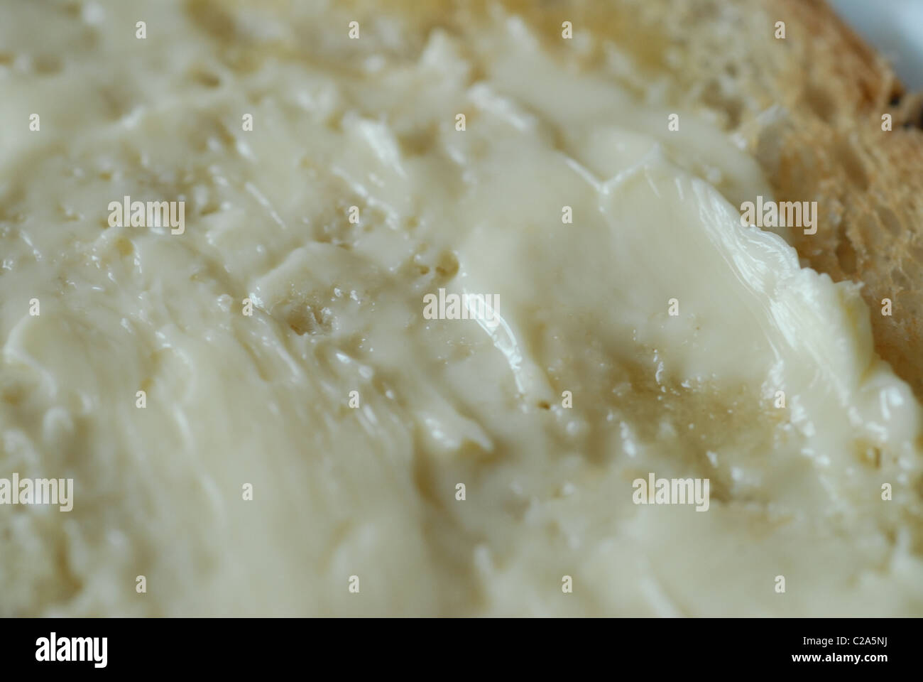 Melted spread on toasted white bread Stock Photo Alamy
